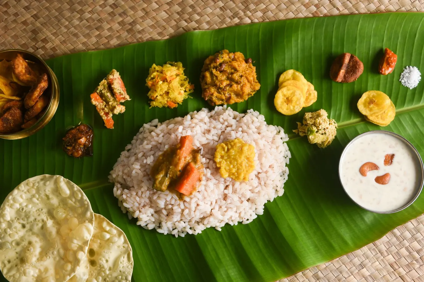 An Onam sadya laid out on a banana leaf