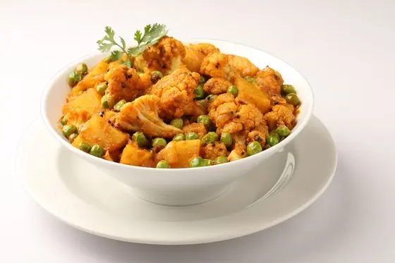 Mixed vegetable curry in a copper bowl